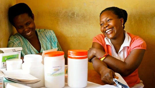 An Abundance of Pleasure Is Possible For All two women sitting laughing